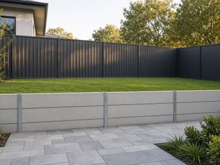 Colorbond fence above a concrete sleeper retaining wall