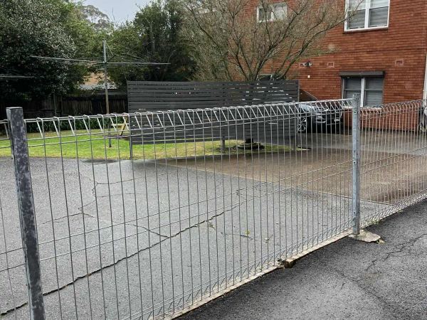 New galvanised steel roll-top mesh fence on the same apartment boundary